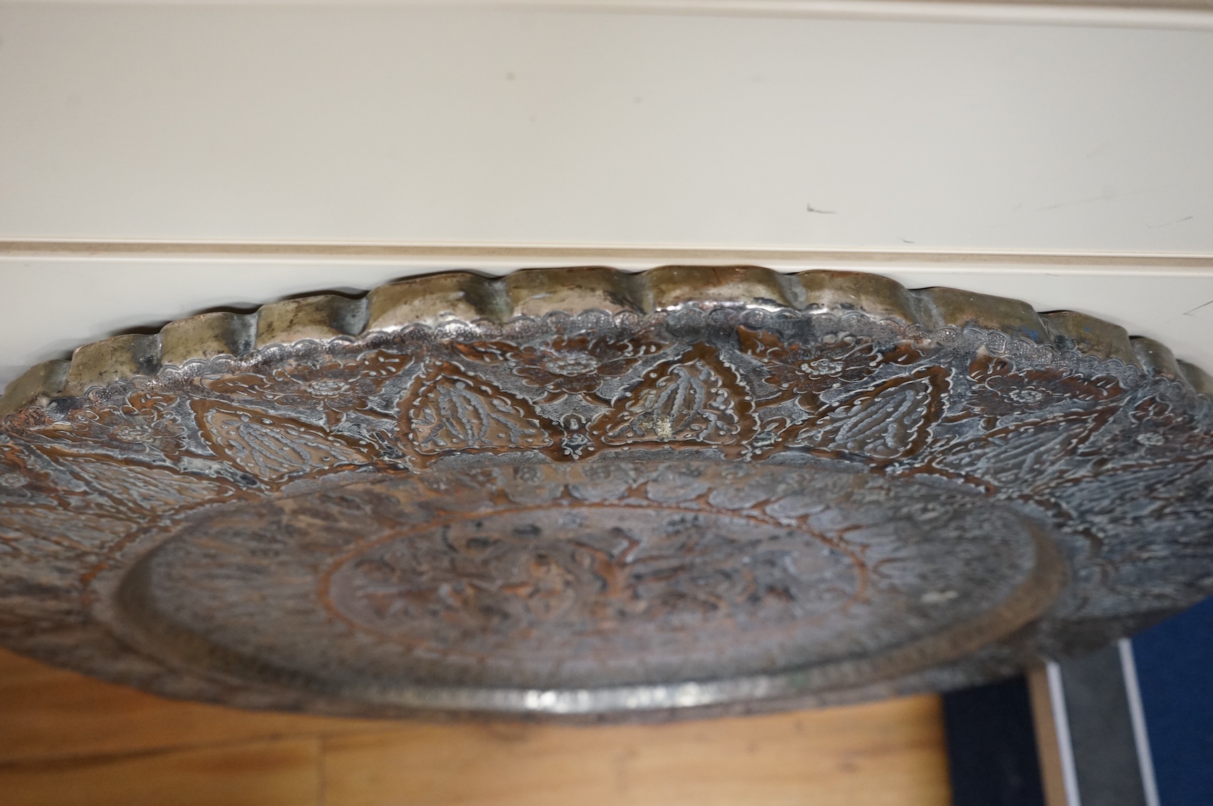 A circular Persian tinned copper embossed tray 88cm diameter